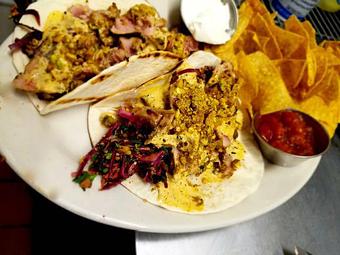 Product: The triple T Tequila tuna taco with citrus tequila marinated tuna served on a grilled tortilla on a bed of spicy red cabbage sesame slaw, topped with a honey siracha aioli and dusted crushed pistachio. - The Brass Ring in Madison, WI Bars & Grills