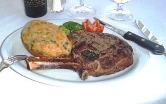 Product: Beautiful Bone-in Rib-eye Paired with Twice Baked Potato - The Caboose Restaurant in Located in Beautiful Downtown McComb - McComb, MS Cajun & Creole Restaurant