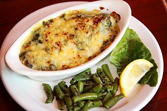 Product: A chicken breast or Catfish fillet smothered in a rich spinach and cheese sauce then browned and served over rice or in an au gratin dish. - The Crown Restaurant in Indianola, MS American Restaurants