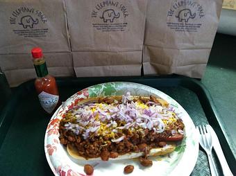 Product: Grilled Hot Dog on a Toasted Roll Topped off with our Homemade Chili loaded with Cheese and Onions - The Elephant Shack in Woodland, CA American Restaurants