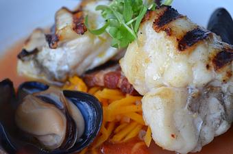 Product: Grilled Local Monkfish,
Kimchi, Squash, Bacon, Mussel Broth - The Frog & The Peach in New Brunswick, NJ American Restaurants