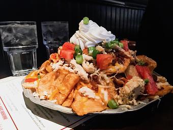 Product: House-made kettle potato chips on a bed of mashed potatoes layered with a blend of cheeses, bacon, tomatoes, chives, & sour cream. - The Original Patsy's Irish Pub, Laguna Niguel in Laguna Niguel, CA Bars & Grills