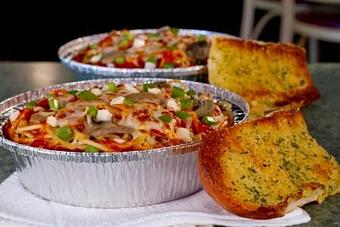 Product: Baked Spaghetti with Garlic Bread - The Spaghetti Junction in New Albany, IN Italian Restaurants