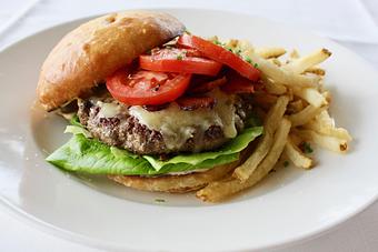 Product: Seasonally inspired menu with daily specials. Pictured: Rick's Deluxe Burger, available at lunch. - The Waterboy in Sacramento, CA American Restaurants