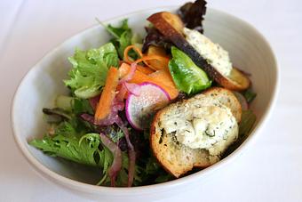 Product: Seasonally inspired menu with daily specials. Pictured: Mixed Baby Lettuces with Baked Goat Cheese Croutons, Cherry Tomatoes & Herb Vinaigrette - The Waterboy in Sacramento, CA American Restaurants