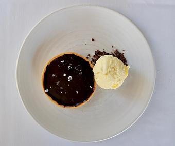 Product: Seasonally inspired menu with daily specials. Pictured: Valrhona Chocolate Tart with Vanilla Ice Cream - The Waterboy in Sacramento, CA American Restaurants