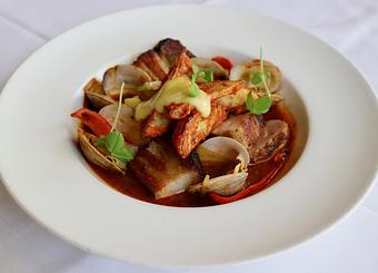 Product: Seasonally inspired menu with daily specials. Pictured: Portuguese Style Pork & Clams with Llano Seco Pork Tenderloin & Belly, Clams, Peppers, Leeks, Fried Potatoes & Romesco - The Waterboy in Sacramento, CA American Restaurants