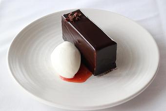 Product: Seasonally inspired menu with daily specials. Pictured: Valrhona Chocolate Mousse Torte with Blood Orange Marmalade, Vanilla Ice Cream - The Waterboy in Sacramento, CA American Restaurants