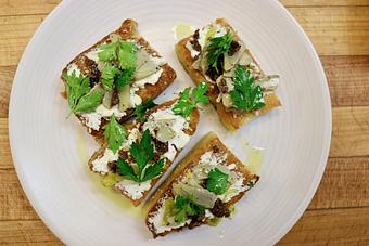 Product: Seasonally inspired menu with daily specials. Pictured: Focaccia with Artichokes, Olives, Herbed Goat Cheese, Parsley, Peperoncini - The Waterboy in Sacramento, CA American Restaurants