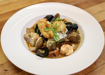 Product: Seasonally inspired menu with daily specials. Pictured: Fish & Shellfish Gumbo with Gulf Shrimp, Clams, Mussels, Various Fish & Andouille Sausage with Jasmine Rice, Scallions & Cajun Spices - The Waterboy in Sacramento, CA American Restaurants