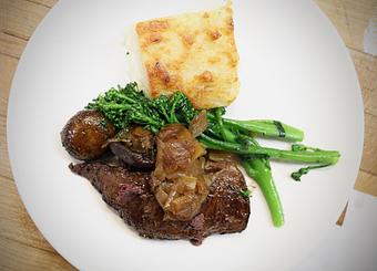 Product: Seasonally inspired menu with daily specials. Pictured: Steak du Jour with Sautéed Broccolini, Potato Gratin, Roasted Mushrooms, Red Wine-Shallot Butter Sauce - The Waterboy in Sacramento, CA American Restaurants