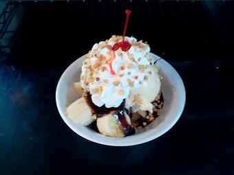 Product: This one is not "naked" as vanilla ice cream was added!  It is warm brownies topped with a sliced banana, vanilla ice cream, hot fudge, whipped cream, nuts and a cherry! - The Widow's Walk Ice Creamery & Bicycle Rentals in Clarksville, IN American Restaurants