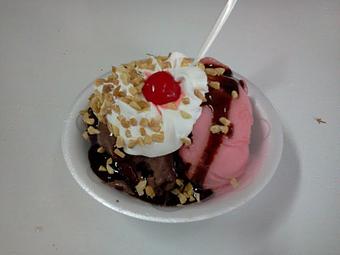 Product: This Raspberry Truffle Sundae is made by starting with warm brownies, top it with a scoop of dark chocolate ice cream, raspberry sorbet, hot fudge, whipped cream nuts and a cherry! - The Widow's Walk Ice Creamery & Bicycle Rentals in Clarksville, IN American Restaurants