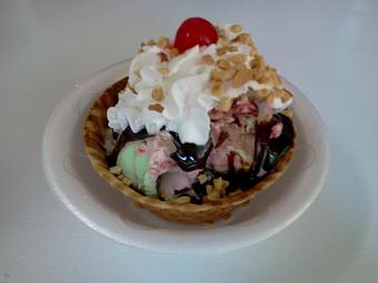 Product: We start with a waffle bowl, add spumoni ice cream which is a swirl of chocolate pistachio and cherry ice cream, add hot fudge, whipped cream, nuts and a cherry! - The Widow's Walk Ice Creamery & Bicycle Rentals in Clarksville, IN American Restaurants