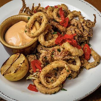 Product: Buttermilk Fried Calamari
Tossed with candied chilies, chipotle aioli, grilled AZ lemon - Tonto Bar & Grill in Rancho Manana - Cave Creek, AZ American Restaurants