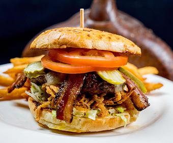 Product: 8 oz wood-grilled patty with sharp cheddar -or- pepper jack. Lettuce,tomato, pickle, and crispy onions on a freshly baked bun - Tonto Bar & Grill in Rancho Manana - Cave Creek, AZ American Restaurants