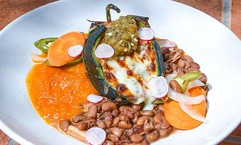 Product: Pork Tamale Relleno GF
Roasted poblano chile pepper stuffed with braised mojo pork, diablo pepper mix, roasted hatch chile salsa, Oaxaca cheese, ranchero sauce, charro beans, and escabeche vegetables - Tonto Bar & Grill in Rancho Manana - Cave Creek, AZ American Restaurants