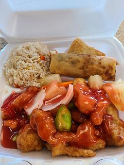 Product: Breaded white meat chicken with some green peppers, white onions, carrots and pineapple chunks with sweet and sour sauce over it - Tsing Tsao Chinese Fast Food in Des Moines, IA Chinese Restaurants