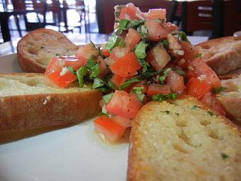 Product: Fresh Garlic Butter toasted on Ca'Doro bread, topped with fresh diced roma tomatoes, garlic,basil and ev olive oil.  Yum! - Union Pizza Company in Border of El Segundo and Manhattan Beach - Manhattan Beach, CA Pizza Restaurant