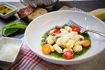 Product: Pesto Gnocchi Served with Pine Nuts and Cherry Tomaotes - Vincent Chiccos in Upper King St, in Downtown Charleston - Charleston, SC Italian Restaurants