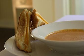 Product: Homemade Bacon Cheese Bread alongside a Cup of Tomato Bisque - Virginia's On King in Historic Downtown Charleston - Charleston, SC American Restaurants