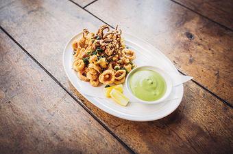 Product: Crispy Fried Calamari with Capers, Parsley, Lemon, & Gremolata Aioli - Wolfgang Puck Bar & Grill in Downtown LA/LA Live - Los Angeles, CA American Restaurants