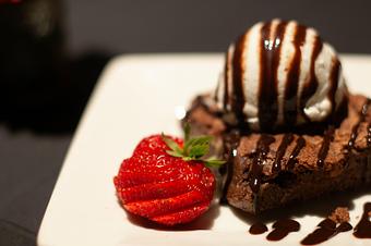 unclassified: Fresh-baked walnut brownie served with vanilla bean ice cream and chocolate sauce. - Midtown Cafe in Nashville, TN American Restaurants unclassified: Fresh-baked walnut brownie served with vanilla bean ice cream and chocolate sauce. - Midtown Cafe in Nashville, TN American Restaurants