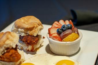 Product: Two Biscuits with fried Chicken tenderloin and two eggs any way served
with a side of Alabama white sauce & sausage gravy - also available “Nashville Hot” w/ Ranch. Served with your choice of home fries, fresh fruit or smoked gouda grits. - Midtown Cafe in Nashville, TN American Restaurants Product: Two Biscuits with fried Chicken tenderloin and two eggs any way served
with a side of Alabama white sauce & sausage gravy - also available “Nashville Hot” w/ Ranch. Served with your choice of home fries, fresh fruit or smoked gouda grits. - Midtown Cafe in Nashville, TN American Restaurants