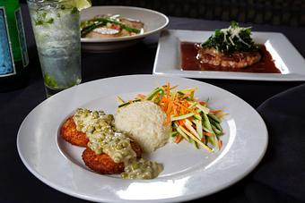 Product: Pan sautéed classic Southern croquettes topped with sweet pea cream sauce,
served with rice pilaf and vegetable medley confetti. - Midtown Cafe in Nashville, TN American Restaurants Product: Pan sautéed classic Southern croquettes topped with sweet pea cream sauce,
served with rice pilaf and vegetable medley confetti. - Midtown Cafe in Nashville, TN American Restaurants