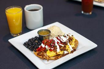 Product: Scrambled eggs with peppers, onions, and chorizo on fried corn tortillas
served with pico de gallo, lime crema and a side of black beans and salsa verde. - Midtown Cafe in Nashville, TN American Restaurants Product: Scrambled eggs with peppers, onions, and chorizo on fried corn tortillas
served with pico de gallo, lime crema and a side of black beans and salsa verde. - Midtown Cafe in Nashville, TN American Restaurants