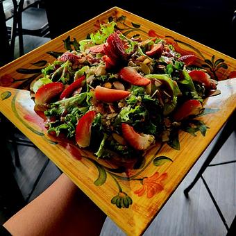 Product: Gorgonzola, strawberries and sliced almonds over a bed of crispy greens. Dressed with Raspberry vinaigrette. - Nikolas Pizza in Newport, RI Pizza Restaurant