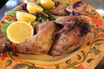 Product: Bone in chicken seasoned with olive oil, fresh lemon, herbs & spices. Served with warm pita bread & side of Greek salad. Half 17.95  Whole 21.95 - Nikolas Pizza in Newport, RI Pizza Restaurant