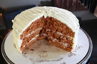 Product: Three layers of spiced cake with carrots, raisins and cream cheese frosting. - Nikolas Pizza in Newport, RI Pizza Restaurant