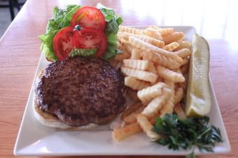 Product: Half pound burger grilled to your desired temperature. Served on bulky roll with lettuce, tomato, onion, French fries and a pickle. 12.50 - Nikolas Pizza in Newport, RI Pizza Restaurant