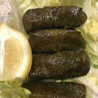 Product: Grape leaves stuffed with seasoned rice served on a bed of crisp lettuce. Drizzled with extra virgin olive oil and fresh lemon. 9.25 - Nikolas Pizza in Newport, RI Pizza Restaurant