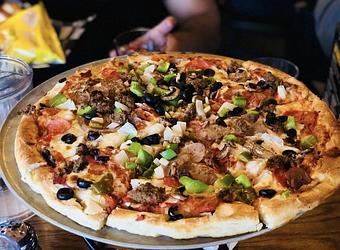 Product: Pepperoni, meatballs, sausage, chourico, onion, green pepper, black olive, and mushroom atop our cheese pizza. - Nikolas Pizza in Newport, RI Pizza Restaurant