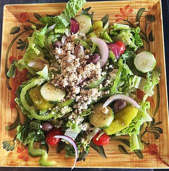 Product: Tomato, cucumber, red onion, green pepper, kalamata olive, and pepperoncini over a bed of crisp romaine lettuce. Topped with Feta cheese. Dressed in extra virgin olive oil, balsamic vinegar, herbs & spices. - Nikolas Pizza in Newport, RI Pizza Restaurant