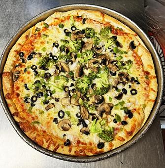 Product: Our traditional cheese pizza topped with black olive, onion , mushroom, green pepper, broccoli and breaded eggplant. - Nikolas Pizza in Newport, RI Pizza Restaurant