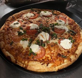 Product: Sliced tomato, Ricotta cheese and fresh basil atop our traditional cheese pizza. - Nikolas Pizza in Newport, RI Pizza Restaurant