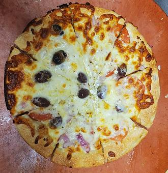 Product: Extra virgin olive oil and fresh garlic base topped with Feta cheese, sliced tomato, red onion and kalamata olives. - Nikolas Pizza in Newport, RI Pizza Restaurant