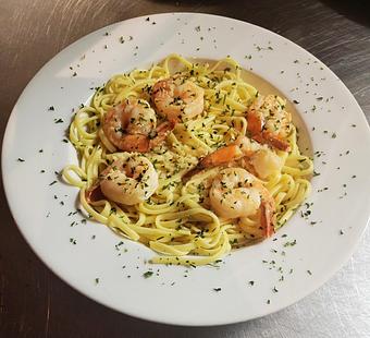 Product: Half dozen shrimp sauteed with garlic in extra virgin olive oil and white wine, then blended with sweet creamy butter. Choice of pasta served with garlic bread. 21.95 - Nikolas Pizza in Newport, RI Pizza Restaurant