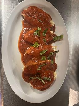 Product: Jumbo shells stuffed with a blend of ricotta and Pecorino Romano cheese, extra virgin olive oil and fresh garlic. Simmered in our marinara sauce served piping hot. - Nikolas Pizza in Newport, RI Pizza Restaurant