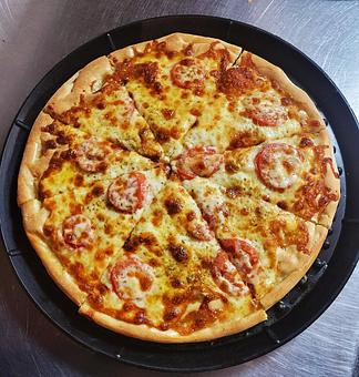 Product: Extra virgin olive oil and fresh garlic base topped with sliced tomato and oregano. - Nikolas Pizza in Newport, RI Pizza Restaurant