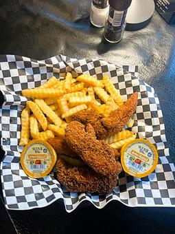 Product: Chicken tenderloins lightly breaded and deep fried. Served with French fries and a side of Honey mustard. Available as Original, Buffalo, East West, Teriyaki, BBQ and Chesapeake. - Nikolas Pizza in Newport, RI Pizza Restaurant