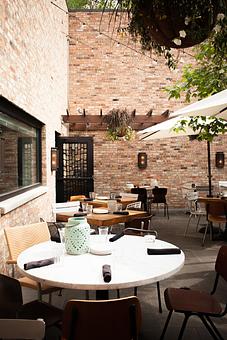 Exterior: vintage brick patio with retractable roof and fireplace - Stella Barra Pizzeria & Wine Bar in Chicago, IL Pizza Restaurant