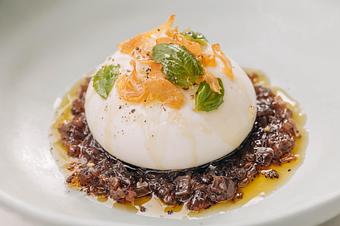 Product: burrata on a bed of red onion & poppy seed jam, crispy garlic & petite basil, garnished with olive oil salt & black pepper, side of ciabatta bread - Pizzeria Portofino in Chicago, IL Pizza Restaurant