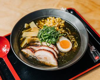 Product: Our shoyu ramen features a clean Chintan style broth, packed with bonito, nori and hondashi. Chicken thigh braised in shoyu until tender, buttered corn, house marinated menma, molten egg, green onion curls, and finished with white pepper. - Ramen San in Chicago, IL Restaurants/Food & Dining