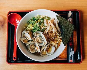 Product: featuring our classic chicken broth with shio salt, 10 clams sauteed with garlic and chili, topped with mushrooms, scallions, fried garlic, sesame, oregano, and a fresh squeeze of lemon - Ramen San in Chicago, IL Restaurants/Food & Dining