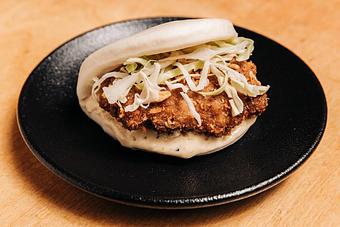 Product: (limited edition: tsukune, a japanese chicken meatball, seasoned with five spice, garlic, and soy topped with shredded cabbage and kewpie mayo on a pillowy mantou bun) - Ramen San in Chicago, IL Restaurants/Food & Dining