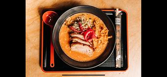 Product: a citrusy pork broth and tokyo wavy noodles with slow roasted pork belly, fresh cabbage & herb salad and crispy tortilla strips - Ramen San in Chicago, IL Japanese Restaurants